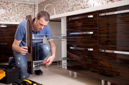 A man installing a kitchen